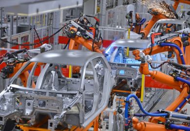 Robots welding in factory