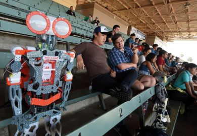 A robot sitting with spectators