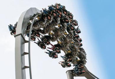 A roller coaster at the top of a loop