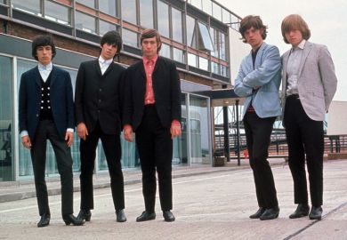 Rolling Stones posing beside airport runway
