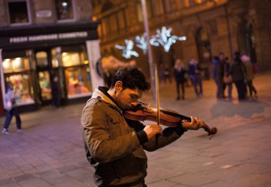 Roma youth playing violin