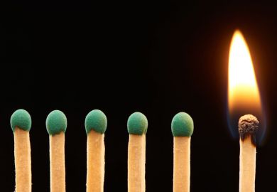 Row of green matches, one burning