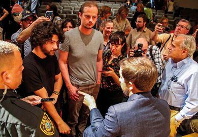 A trustee for New College of Florida, Christopher Rufo, talks with students