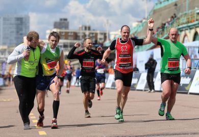 Runners crossing the finish line, Brighton Marathon 2016