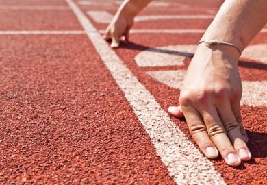 Runner's hands placed in race starting position Runner's hands placed in race starting position