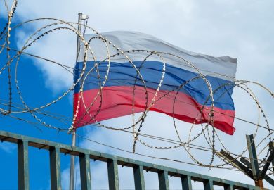 The Russian flag behind barbed wire The Russian flag behind barbed wire