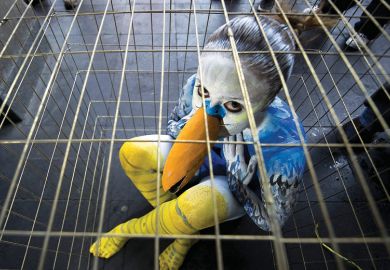 Sad young woman dressed as bird in cage