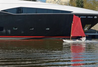 Tiny boat next to luxury yacht