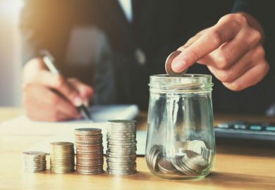 putting coins in a jar representing college and university fees