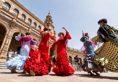 Seville, Spain - May 2017 Young women dance flamenco on Plaza de Espana during famous Feria festival