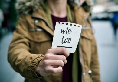 Woman holding a "me too" sticker