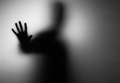 An indistinct person pressing their hands against a barrier illustrating absence of adjunct and non-tenure-track faculty in The Chair on Netflix