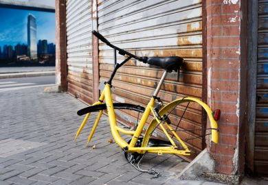 Shanghai, China - April 08, 2017 Discarded and vandalized bicycle of popular bikesharing company ofo laying in the street
