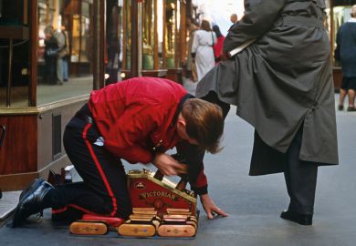 Shoeshine boy polishing man's shoes