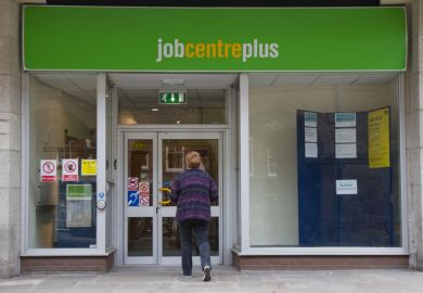 Shrewsbury, Shropshire, UK - May 5th 2014 Woman walks towards door of Job Centre Plus in Shrewsbury town center, Shropshire.