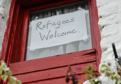 Sign on a window saying Refugees Welcome