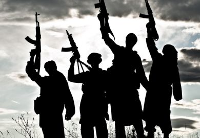 Silhouettes of Islamic terrorists aiming guns at sky