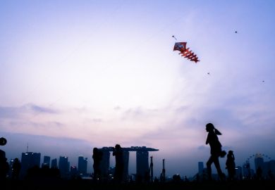 Singapore, Singapore - August 22th, 2015 The kids are playing with the kite on top of the Marina Barrage.