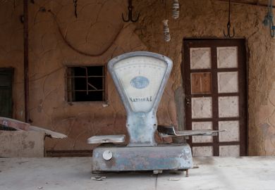 Dusty set of scales outside a closed shop in Siwa, Egypt, 2018 Dusty set of scales outside a closed shop in Siwa, Egypt, 2018