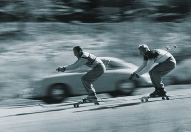 Skiers racing car down hill