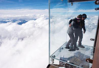 People standing on a glass viewing platform People standing on a glass viewing platform