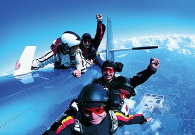 A group of skydivers clinging to a plane