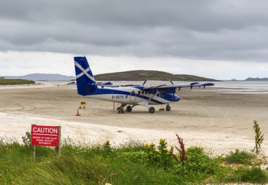 Small plane on the sandy runway of Barra Airport, Scotland Small plane on the sandy runway of Barra Airport, Scotland