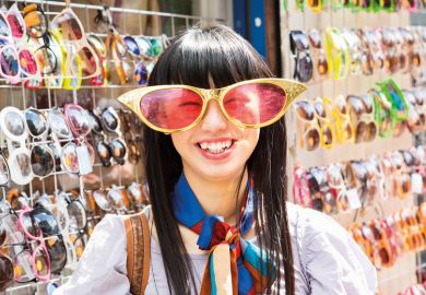 Smiling young woman wearing comedy sunglasses