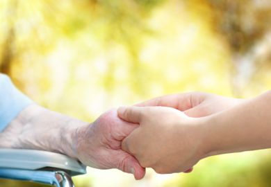Old woman olding carer's hand Old woman olding carer's hand
