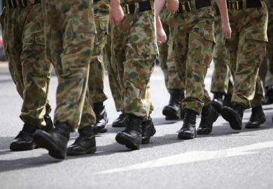 Soldiers in camouflage fatigues marching
