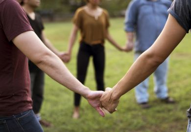 istock solidarity People in a circle holding hands