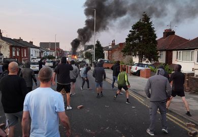 Protesters throw stones at police after disorder broke out on July 30, 2024 in Southport, England. Rumours about the identity of the 17-year-old suspect in yesterday's deadly stabbing attack here have sparked a violent protest.