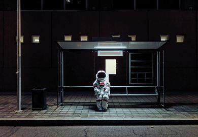An astronaut sits at a bus stop to illustrate being left behind