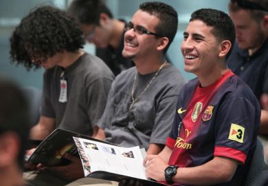 Jose Garcia, right, and Joel Hernandez laughing during a tour for engineering students from California State Polytechnic University to illustrate US Hispanics rising through higher education
