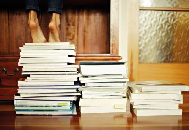 Standing on a pile of books
