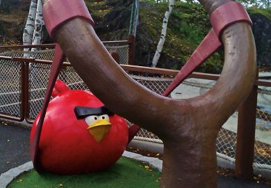 Statue of Angry Birds game character being shot from catapult