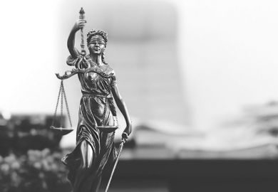 Statue of Lady Justice in academic's office