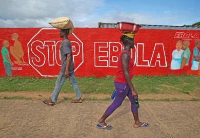 Stop Ebola sign written on wall