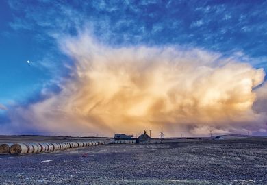 Storm gathering over farmland