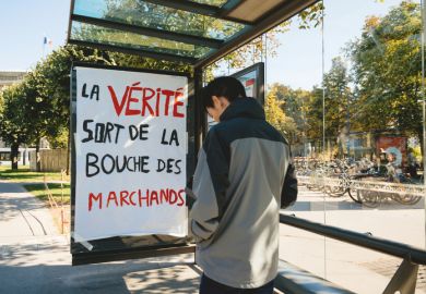 Strasbourg, France - Sep 21, 2019 Man in front of protest placard at bus station during the largest worldwide climate march change started by Swedish climate activist Greta Thunberg