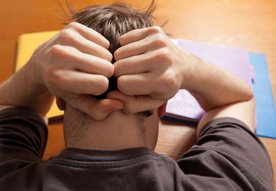 Stressed male student suffering from anxiety Stressed male student suffering from anxiety