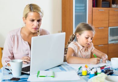 stressed-woman-with-child-working-from-home stressed-woman-with-child-working-from-home