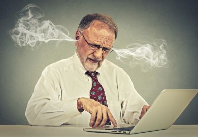 Stressed man at computer