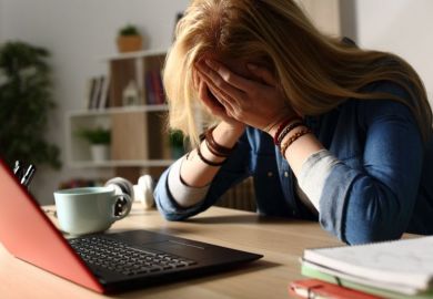Stressed PhD student at laptop Stressed PhD student at laptop