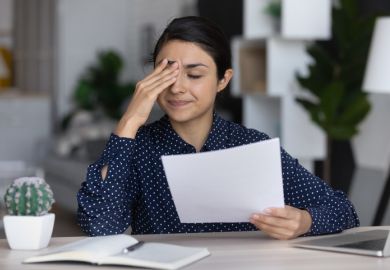 Stressed upset employee holding document with bad dismissal news