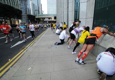 Runners try and stretch out their fatigue during the London Marathon Runners try and stretch out their fatigue to illustrate Low completion rates put OU on collision course with regulator