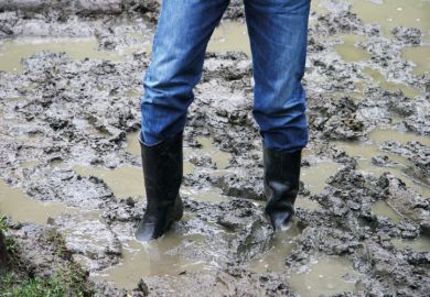 Man wearing boots stuck in the mud