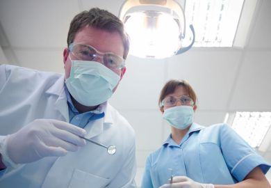 Student and dentist in dental surgery Student and dentist in dental surgery