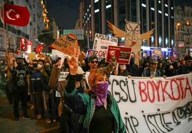 Students walk behind a banner reading "The university is boycotting. Tayyip resign (in reference to Turkey's President Recep Tayyip Erdogan)" march along a street during a rally in support of Istanbul's arrested mayor, in Istanbul, on 25 March 2025