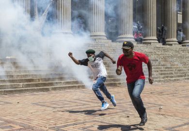 Students running during protest, University of the Witwatersrand Students running during protest, University of the Witwatersrand
